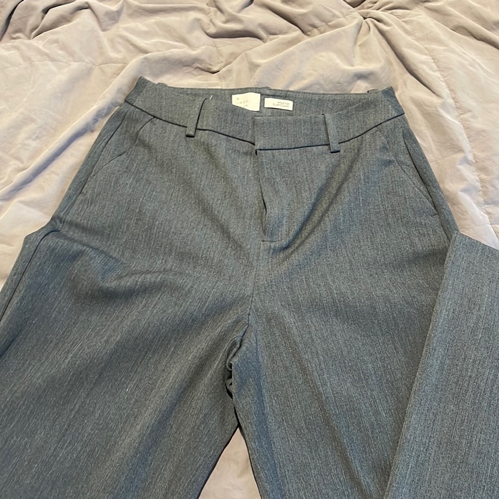 Grey dress pants, never worn, still pressed and ready to wear.